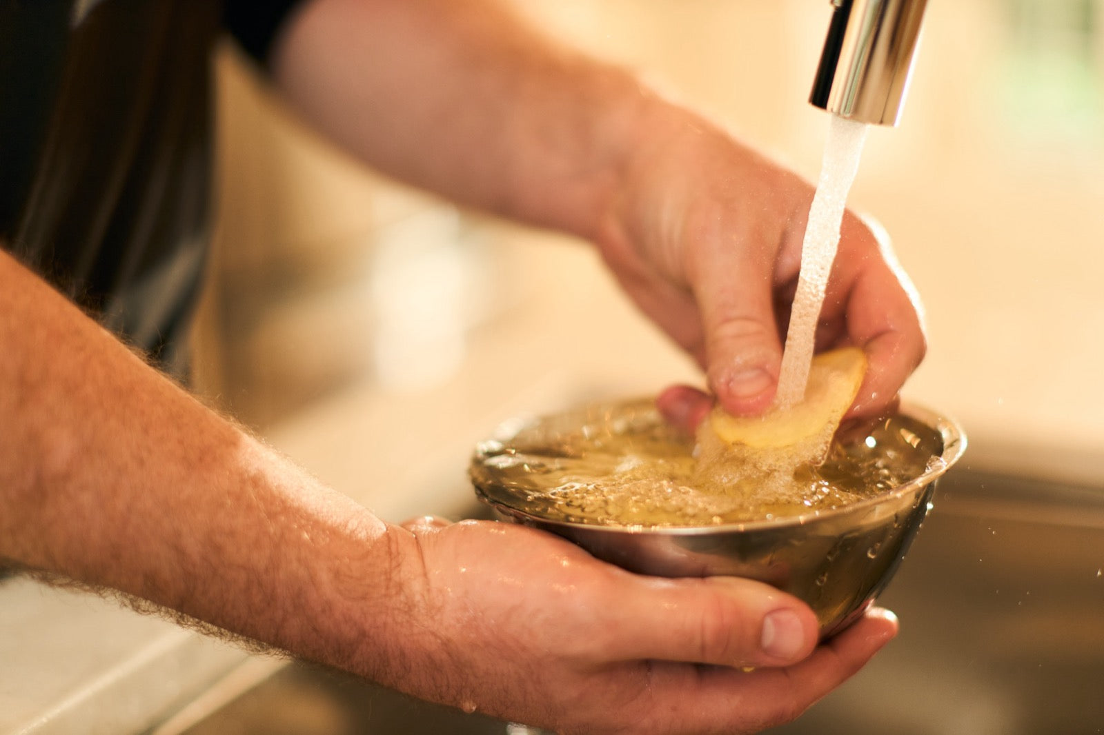 Potato slices being rinsed